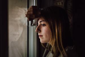 Woman looks out window