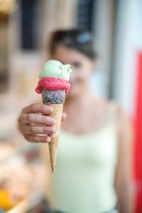 Young woman holds an ice cream cone