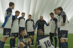 A coach talks to the players