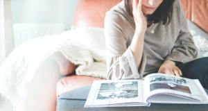 Woman contemplates photos in a book