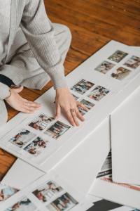 Woman sits on floor with photo album