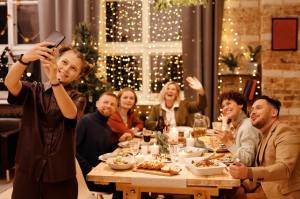 Family group at holiday dinner taking selfie