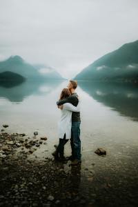 Couple stand together by a lake