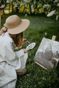 woman outdoors painting with watercolors
