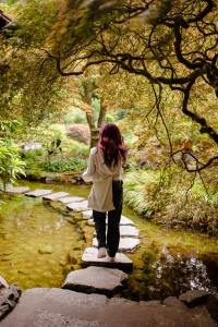 Woman walking on stone path over river